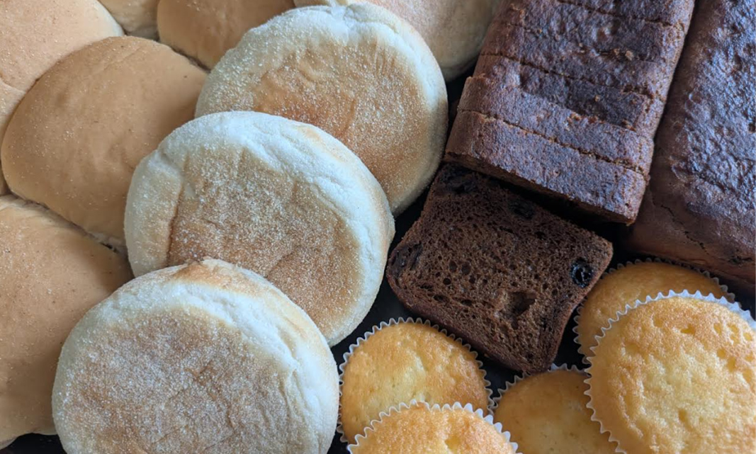 A selection of freshly baked goods, including bread, pastries, and cakes.