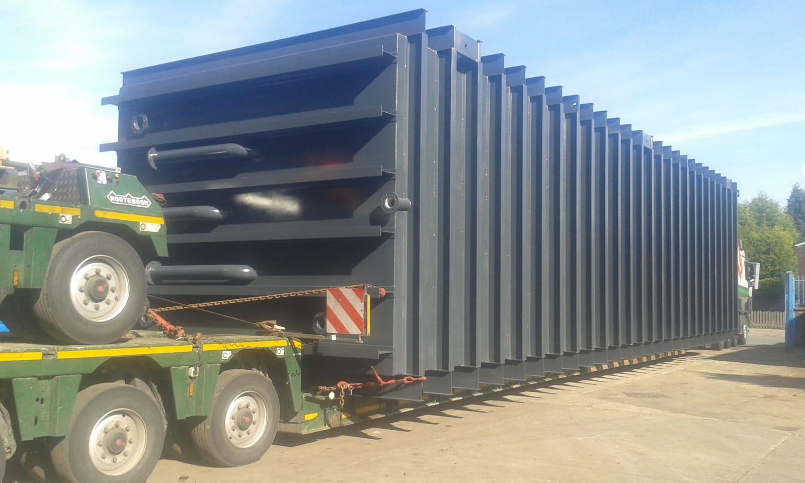 A picture of a vacuum cooler, in transport, that fits an entire trailer inside with produce to be cooled.